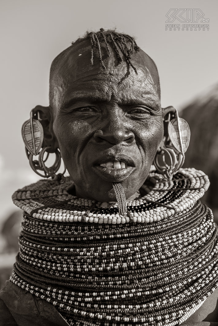 Lake Turkana - Turkana woman Turkana women adorn themselves with numerous necklaces and earrings in the shape of a leaf. This older woman has a chin decoration from twisted strands of copper. It is common for older woman but it's very much dying out with the younger generations. Stefan Cruysberghs